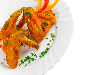 Image showing Fried chicken wings with legs his chopped pepper, onion and fenn