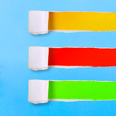 Image showing assortment torn of ripped blue green yellow red paper against co