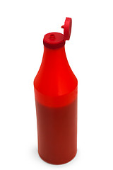 Image showing red plastic ketchup bottle isolated on white