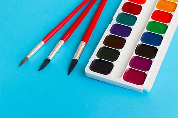 Image showing brushes for watercolors paints children on blue background