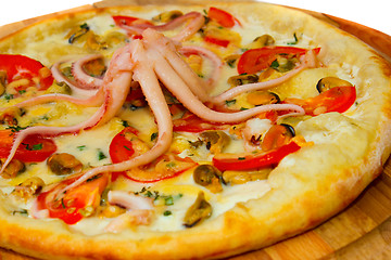 Image showing pizza Appetizing with octopus seafood on a wooden tray isolated 