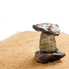 Image showing cairn in the sand is isolated