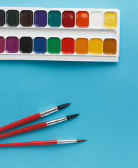 Image showing watercolors children brushes watercolor paints on blue backgroun