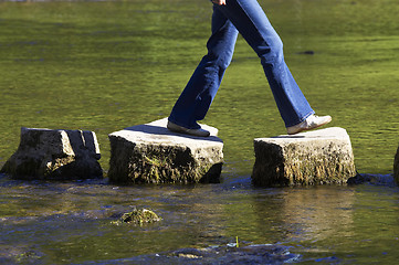 Image showing crossing three stepping stones in a river