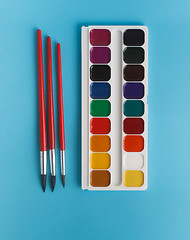 Image showing brushes for watercolors and watercolor paints for children on a