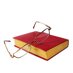 Image showing glasses and a red book isolated on white background