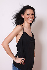 Image showing A woman in a black undershirt with tousled hair