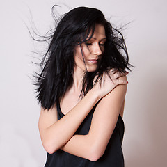 Image showing A woman in a black undershirt with tousled hair