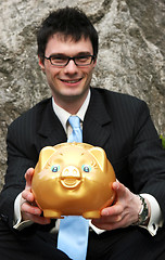 Image showing Businessman and piggy bank.