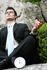 Image showing Businessman meditating outside.