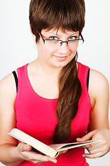 Image showing Young attractive girl holding an open book