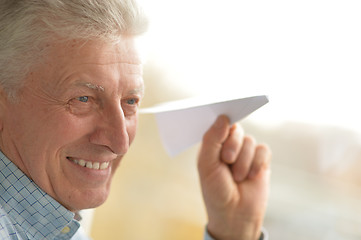 Image showing Senior man with paper plane