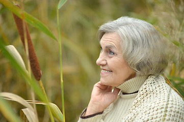Image showing Smiling senior woman in autumn