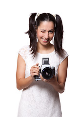 Image showing Retro woman with an old camera