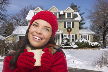 Image showing Smiling Woman in Winter Clothing Holding Mug Outside in Snow