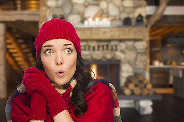 Image showing Mixed Race Girl Enjoying Warm Fireplace In Rustic Cabin