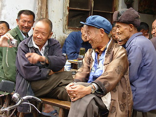 Image showing old men looking at their own image