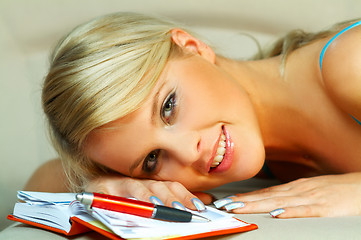 Image showing Blonde woman with datebook