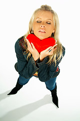 Image showing girl holding a red velvet heart