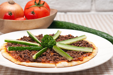 Image showing Turkish beef pizza with cucumber on top