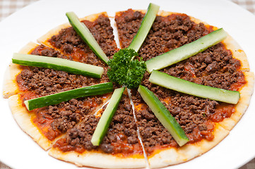 Image showing Turkish beef pizza with cucumber on top