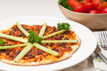 Image showing Turkish beef pizza with cucumber on top