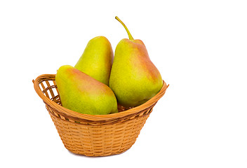 Image showing Large ripe pears in a wicker basket on a white background.