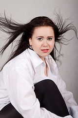 Image showing Disheveled long-haired woman in a white men's shirt