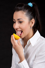 Image showing woman eat yellow lemon