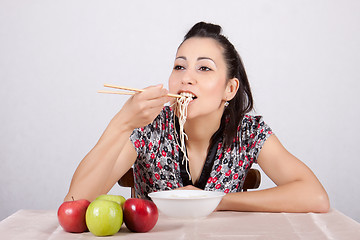 Image showing Woman eat noodles