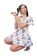 Image showing A girl with pigtails in colorful retro dress