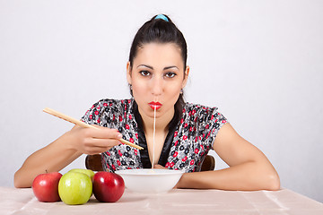 Image showing Woman eat noodles