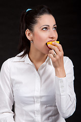 Image showing woman eat yellow lemon
