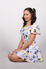 Image showing A girl with pigtails in colorful retro dress