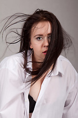 Image showing Disheveled long-haired woman in a white men's shirt