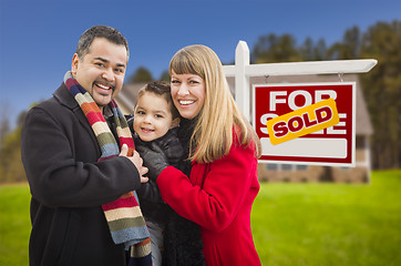 Image showing Family in Front of Sold Real Estate Sign and House