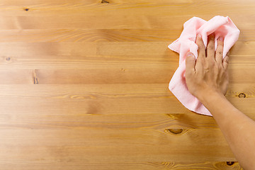 Image showing Cleaning table by pink rag