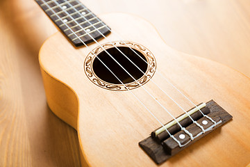 Image showing Ukulele on wood background