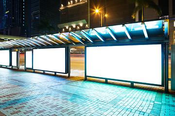 Image showing Night bus station with blank billboard