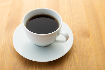Image showing Cup of coffee on wooden table