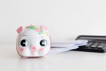 Image showing Piggy bank, calculator and statement