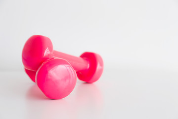 Image showing Two pink glossy dumbbell isolated on white 