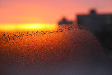 Image showing Background with ice, morning sunlight and silhouettes of houses 