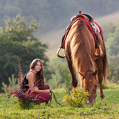 Image showing Young girl with a horse