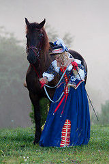 Image showing Woman in dress royal baroque riding