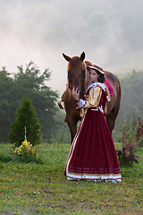 Image showing Woman in dress royal baroque riding