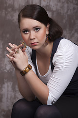 Image showing Girl with long hair in a white shirt and a blue vest