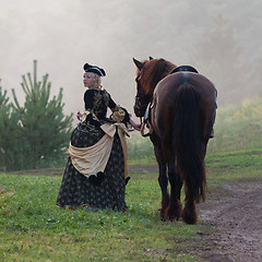 Image showing Woman in dress royal baroque riding