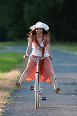 Image showing Retro girl on old bike