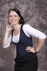 Image showing Girl with long hair in a white shirt and a blue vest